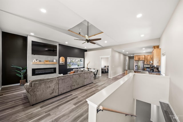 living room featuring ceiling fan and wood-type flooring