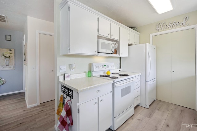 kitchen featuring visible vents, light countertops, light wood-style floors, white appliances, and white cabinetry