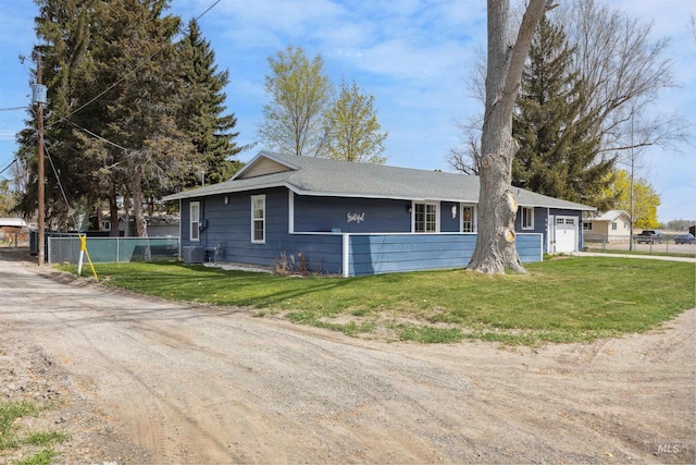 ranch-style home featuring fence, central AC unit, and a front yard