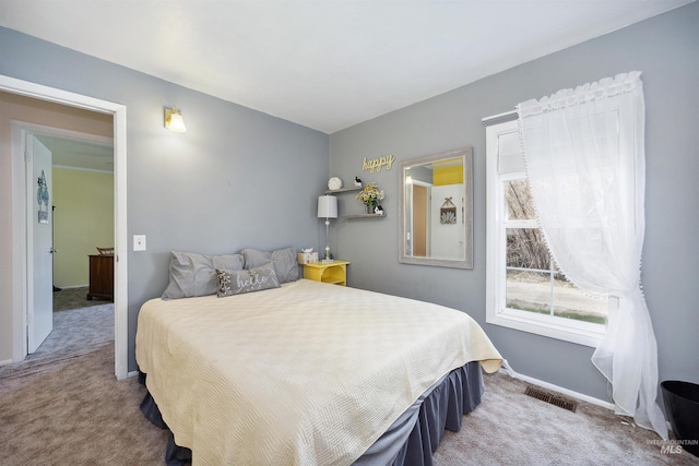 bedroom with carpet floors, baseboards, and visible vents