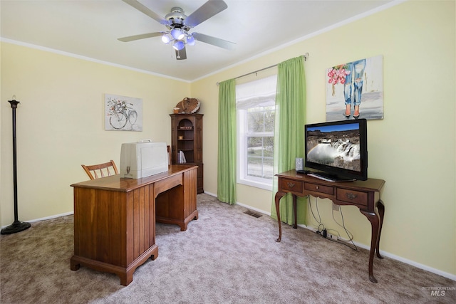 office area featuring baseboards, ornamental molding, ceiling fan, and light carpet