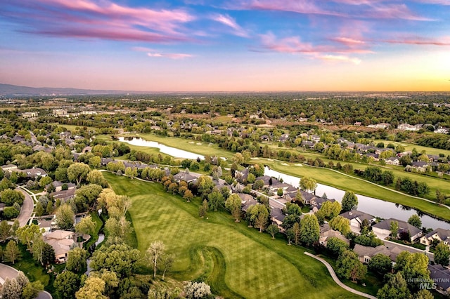 aerial view at dusk with a water view