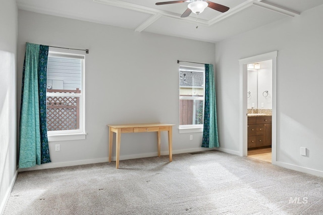 unfurnished bedroom featuring connected bathroom, sink, ceiling fan, light colored carpet, and coffered ceiling