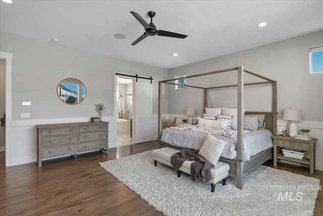 bedroom featuring dark wood-style floors, ceiling fan, a barn door, and recessed lighting