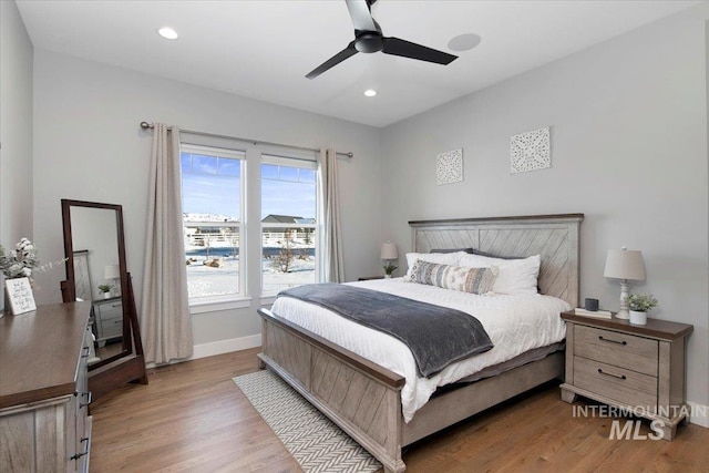 bedroom featuring light wood finished floors, recessed lighting, a ceiling fan, and baseboards