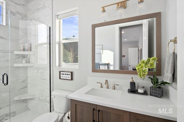 bathroom featuring toilet, vanity, and a marble finish shower