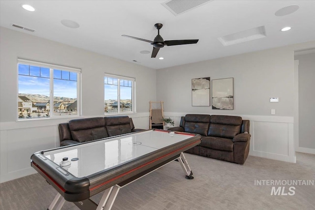 game room featuring light carpet, visible vents, and wainscoting