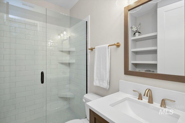 bathroom with visible vents, a stall shower, vanity, and toilet