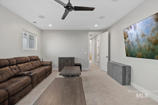 living room featuring recessed lighting, light colored carpet, visible vents, a ceiling fan, and baseboards