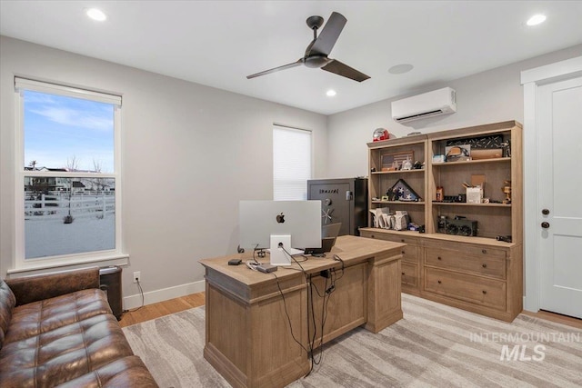 office featuring plenty of natural light, baseboards, ceiling fan, and a wall mounted air conditioner