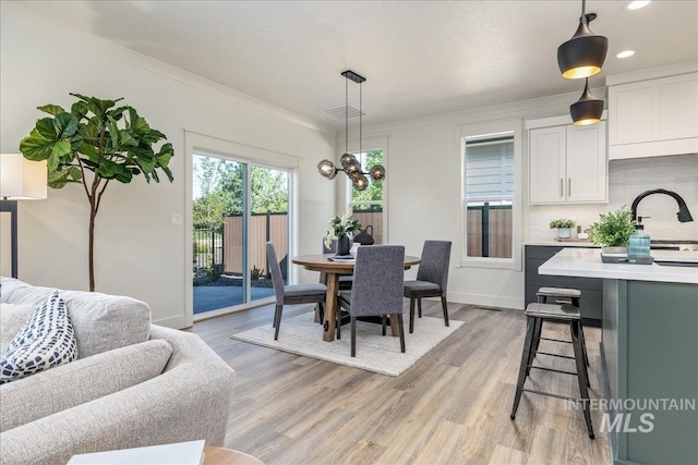 375 N Sauer River Ln, Eagle, ID 83616 - dining space with light wood-style flooring, crown molding, baseboards, and recessed lighting
