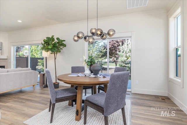 375 N Sauer River Ln, Eagle, ID 83616 - dining area featuring light wood finished floors, ornamental molding, a chandelier, baseboards, and recessed lighting