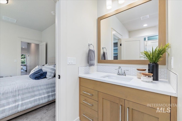 375 N Sauer River Ln, Eagle, ID 83616 - bathroom featuring vanity, decorative backsplash, and connected bathroom