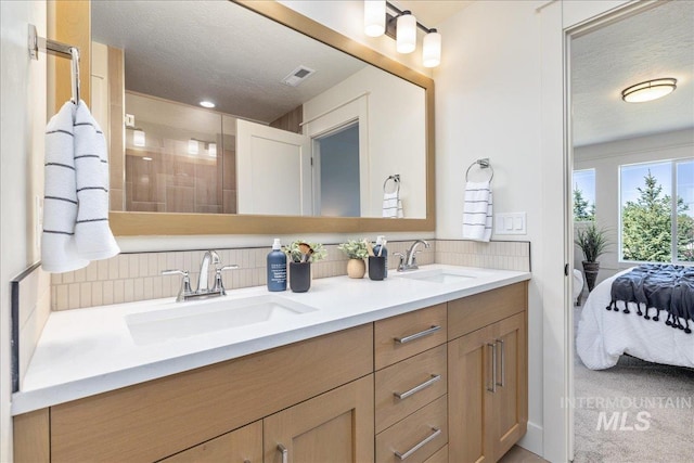 375 N Sauer River Ln, Eagle, ID 83616 - ensuite bathroom with tasteful backsplash, a textured ceiling, double vanity, and a shower