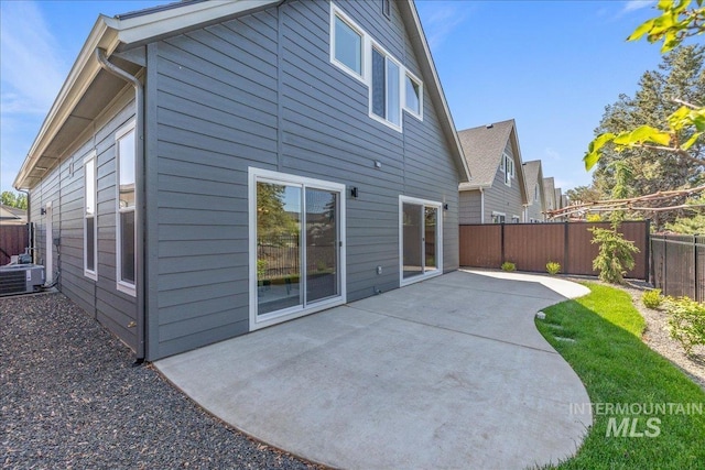 375 N Sauer River Ln, Eagle, ID 83616 - back of property with central AC unit, a patio area, and a fenced backyard