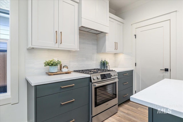 375 N Sauer River Ln, Eagle, ID 83616 - kitchen with stainless steel gas range oven, decorative backsplash, light countertops, and gray cabinetry