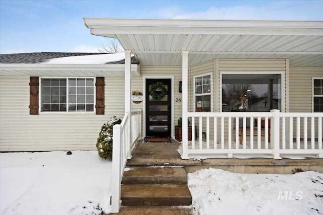 view of snow covered property entrance