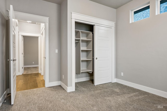 unfurnished bedroom with carpet floors and a closet