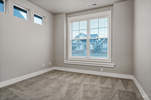 unfurnished room featuring light carpet