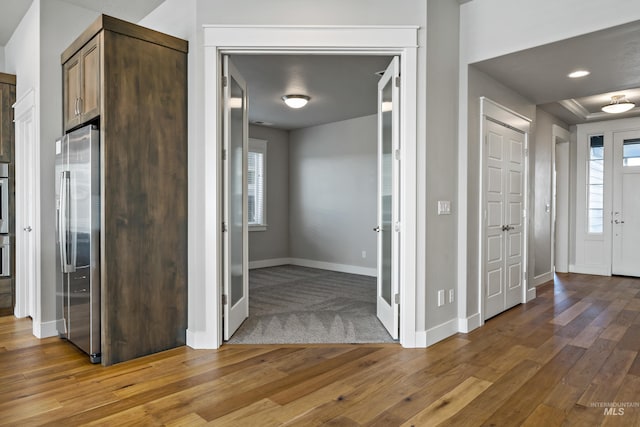 hallway featuring wood-type flooring and plenty of natural light