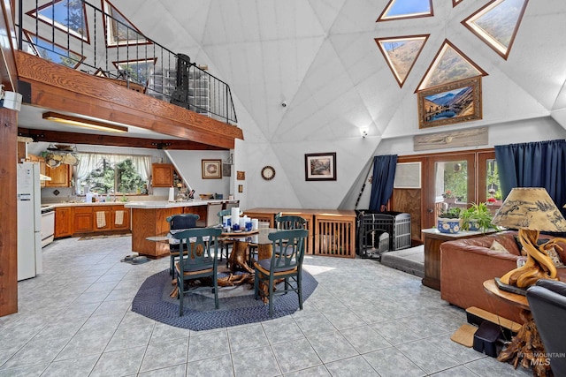 tiled dining space featuring a towering ceiling