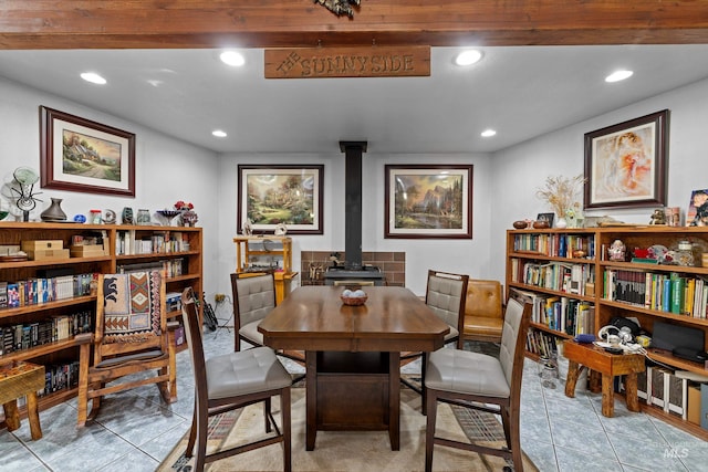 tiled dining room with a wood stove