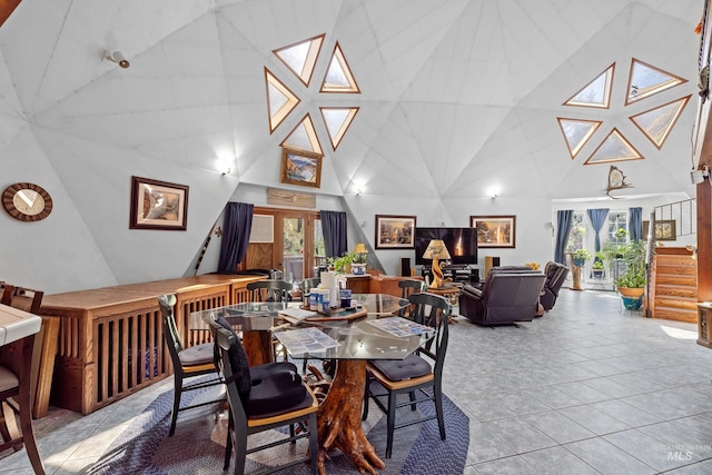 dining area featuring light tile patterned floors and a high ceiling