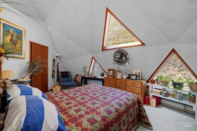 carpeted bedroom featuring vaulted ceiling and multiple windows