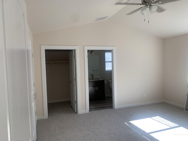 9585 W Sussex, Boise, ID 83704 - unfurnished bedroom featuring a closet, a sink, carpet floors, a walk in closet, and lofted ceiling