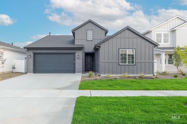 view of front of property with a garage and a front lawn