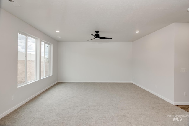 unfurnished room with carpet flooring and ceiling fan