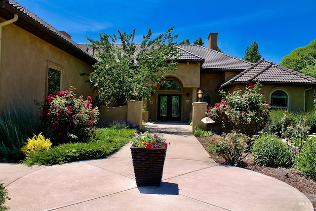 3349 E 4050 N, Twin Falls, ID 83301 - property entrance with french doors, a chimney, stucco siding, and a tiled roof