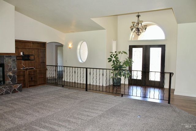 3349 E 4050 N, Twin Falls, ID 83301 - entryway with a chandelier, high vaulted ceiling, a stone fireplace, arched walkways, and french doors