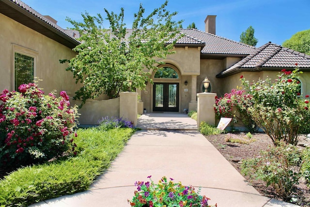 3349 E 4050 N, Twin Falls, ID 83301 - view of exterior entry featuring french doors, a chimney, stucco siding, and a tile roof