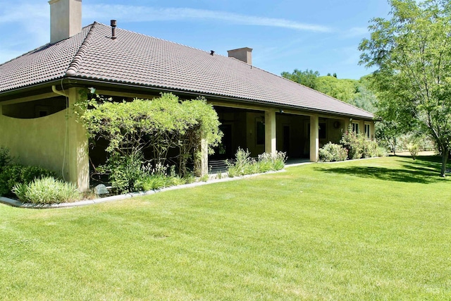 3349 E 4050 N, Twin Falls, ID 83301 - back of house featuring a chimney, a tiled roof, and a lawn