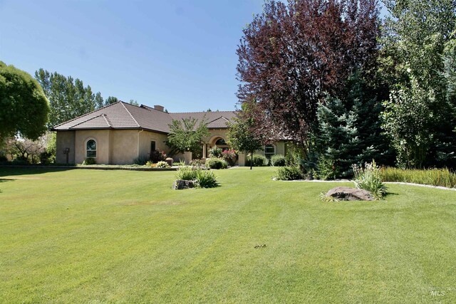 3349 E 4050 N, Twin Falls, ID 83301 - view of front of house featuring a front yard, stucco siding, and a tiled roof