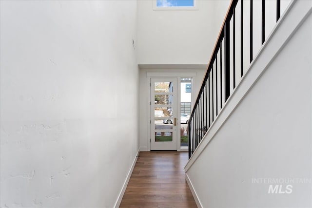 interior space with dark hardwood / wood-style flooring and a high ceiling