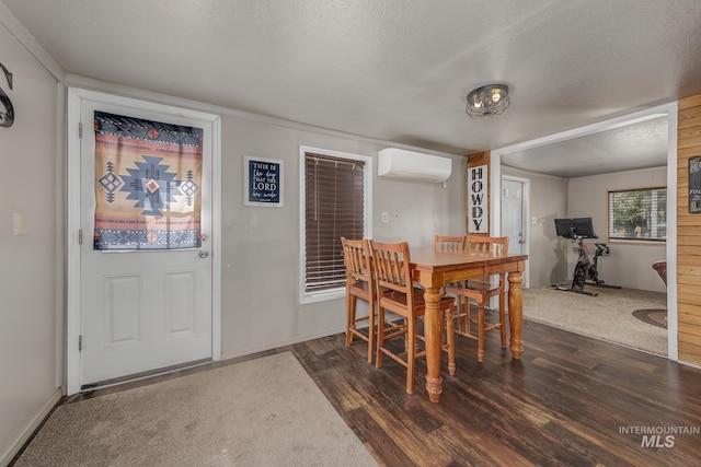 1025 W Galloway Ave, Weiser, ID 83672 - dining space with a wall unit AC, dark wood finished floors, and a textured ceiling