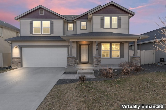3749 E Rock Falls St, Nampa, ID 83686 - craftsman house featuring fence, an attached garage, driveway, a porch, and stone siding