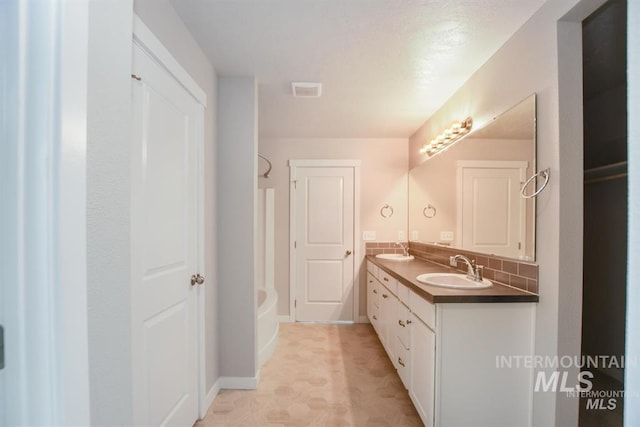 3749 E Rock Falls St, Nampa, ID 83686 - full bath with baseboards, a sink, double vanity, and tub / shower combination