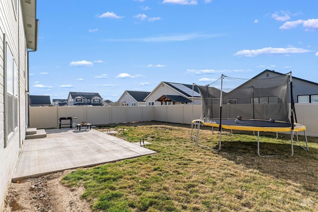 3749 E Rock Falls St, Nampa, ID 83686 - view of yard with a trampoline, a patio area, and a fenced backyard