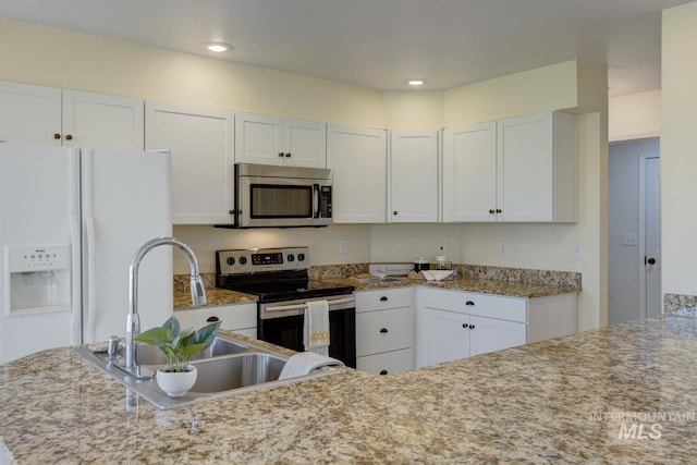 12335 W Red Spruce, Boise, ID 83713 - kitchen featuring stainless steel appliances, white cabinetry, light stone counters, and recessed lighting
