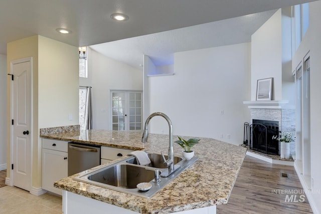 12335 W Red Spruce, Boise, ID 83713 - kitchen featuring white cabinetry, a fireplace, light stone countertops, vaulted ceiling, and recessed lighting