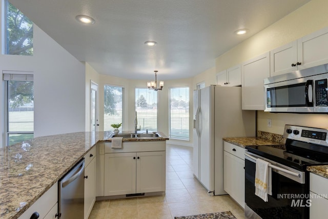 12335 W Red Spruce, Boise, ID 83713 - kitchen with appliances with stainless steel finishes, a chandelier, plenty of natural light, white cabinetry, and recessed lighting