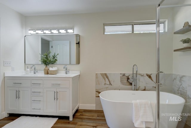 12335 W Red Spruce, Boise, ID 83713 - full bathroom featuring wood finished floors, double vanity, and a soaking tub