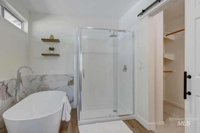 12335 W Red Spruce, Boise, ID 83713 - full bathroom featuring a stall shower, a freestanding tub, wood finished floors, and a walk in closet