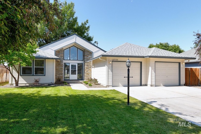 12335 W Red Spruce, Boise, ID 83713 - view of front of house with an attached garage, concrete driveway, roof with shingles, and stone siding