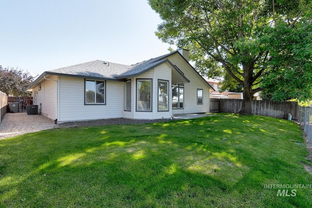 12335 W Red Spruce, Boise, ID 83713 - rear view of house featuring a fenced backyard, a chimney, and a shingled roof