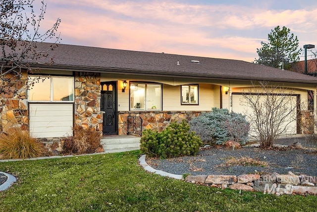 view of front facade featuring a garage, stone siding, a yard, and a porch