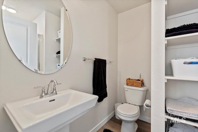 2312 E Spice Loop Unit 3, Nampa, ID 83687 - bathroom with toilet, wood finished floors, a sink, and baseboards